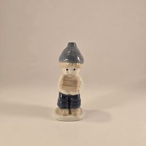 ceramic figurine Dutch Farm young Boy wearing a hat and holding a Pile Of Wood